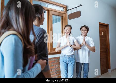 portrait du personnel de la maison d'hôtes asiatique accueillant un couple dans un hôtel boutique Banque D'Images