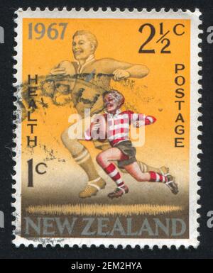 NOUVELLE-ZÉLANDE - VERS 1967: Timbre imprimé par la Nouvelle-Zélande, montre l'équipe nationale Rugby Player and Boy, vers 1967 Banque D'Images