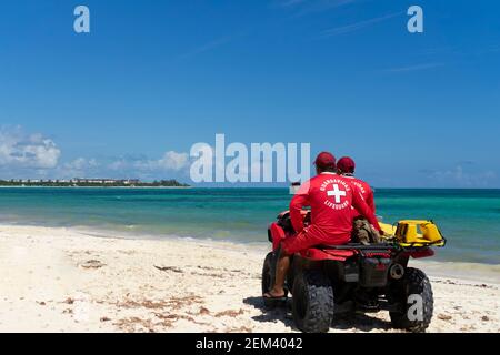 Deux sauveteurs sur un Quad Bike observent l'océan pour surveiller la sécurité de la plage et des baigneurs. Concept de vacances et de protection au Mexique Banque D'Images