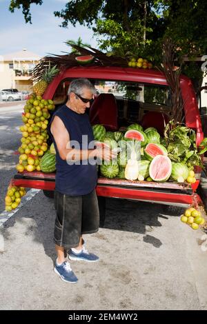 Profil latéral d'un homme senior comptant derrière lui la monnaie papier une voiture Banque D'Images