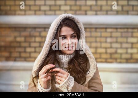 Gros plan portrait mise au point de la capuche satisfait gai élégant belle belle jeune fille heureuse en chandail et blouson look loin de là, alors que p Banque D'Images