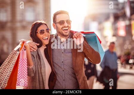 Portrait de couple heureux avec sacs de shopping.People,vente, consumérisme et concept de style de vie. Banque D'Images