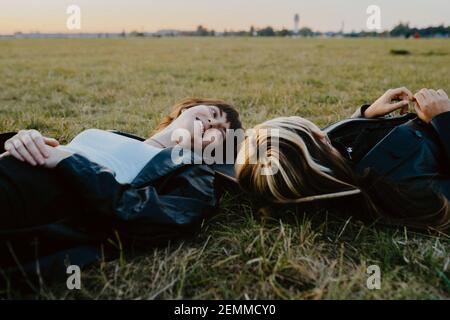 Jeunes amies allongées sur l'herbe dans le parc Banque D'Images