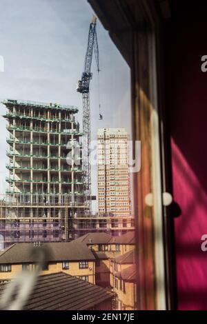 Londres, Royaume-Uni. 23 février 2021. Un tout nouveau bâtiment en construction de Wimpey Homes vu de l'appartement de Dimitri. Dimitri est l'un des activistes locaux soutenant les trois protecteurs d'arbres qui occupent un peuplier noir de 100 ans pour le sauver de l'abattage, depuis la nuit du 21 au 22 février. La coupe a été autorisée afin de faire place à un nouveau câble électrique, qui fait partie du programme de régénération locale des logements par le conseil et Taylor Wimpey Homes. Mais le peuplier, un arbre de catégorie A à valeur ajoutée, ne peut être abattu que s'il existe des raisons convaincantes de le réduire. Banque D'Images