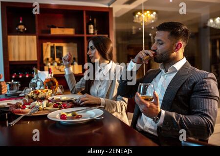 Partenaires d'affaires ayant un dîner dans un restaurant élégant Banque D'Images