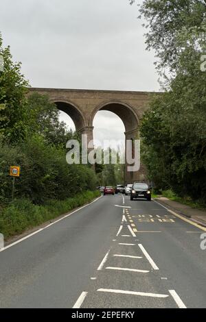 Voitures voyageant le long d'une route sous Chappel Viaduct, Chappel, Colchester, Essex, Royaume-Uni Banque D'Images