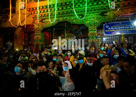 Katmandou, Népal. 27 février 2021. Les gens regardent une procession de chars autour de la Boudhanath Stupa pendant le festival de Mamla à l'intérieur du site du patrimoine mondial de l'UNESCO à Katmandou, au Népal, le samedi 27 février 2021. Crédit: Skanda Gautam/ZUMA Wire/Alay Live News Banque D'Images