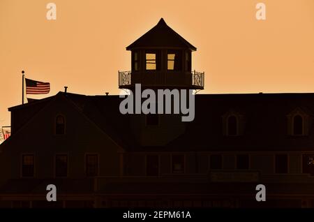 Chicago, Illinois, États-Unis. La lueur d'un lever de soleil de printemps crée une silhouette de la station de sécurité maritime de Chicago avec sa tour distinctive. Banque D'Images