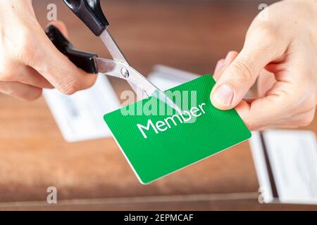 Gros plan image isolée d'UNE jeune femme coupant une carte de membre. Personnalisable avec espace de copie sur la carte. Convient pour réduire les coûts, annulation Banque D'Images