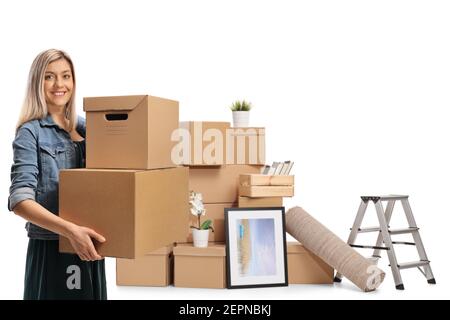 Jeune femme avec boîtes en carton emballées pour l'enlèvement à la maison isolé sur fond blanc Banque D'Images