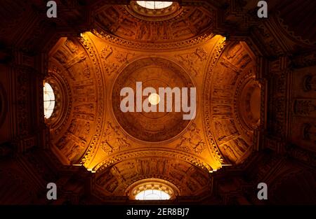 Séville, Espagne 07-12-2010: Vue de bas en haut d'un décor de plafond à l'intérieur de la coupole de la célèbre cathédrale de Séville avec des arches, des fenêtres représentant la religio Banque D'Images