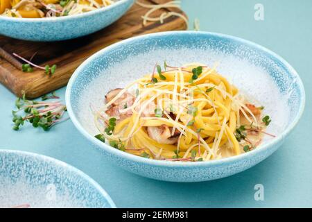 Pâtes faites maison avec jambon, fromage et micro-légumes. Banque D'Images