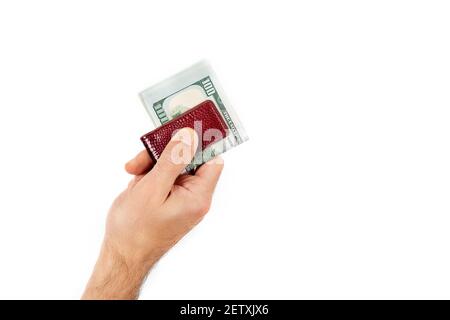 Gros plan de la main d'un homme retient les dollars fixés avec un clip isolé sur un fond blanc. Devise AMÉRICAINE Banque D'Images