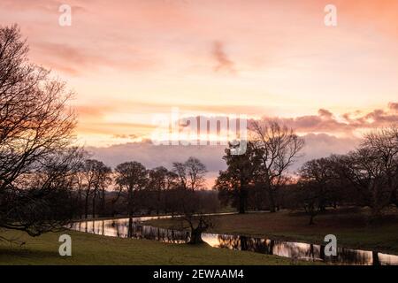 Swinton Park Hotel, Yorkshire. château du xviie siècle entouré d'un parc, lever du soleil en paysage hivernal Banque D'Images