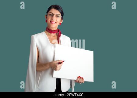 Un élégant professeur de brunette montrant quelque chose sur le tableau blanc vide. Formation en ligne Banque D'Images