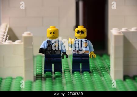 Deux mini-figurines Lego des officiers de police des États-Unis se trouvaient à l'extérieur d'un Maison construite de Lego Banque D'Images