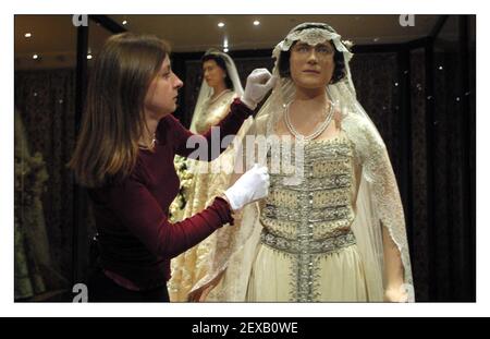 Cinq robes de mariage royales sont exposées ensemble pour la première fois dans les appartements d'état du Palais de Kensington, l'exposition, Acentury of Queens Wedding robes 1840-1947 s'ouvrira au public le 1er mai pour commémorer le Jubilé d'or du Queens. Jenny Lister conservateur adjoint au Palais de Kensington fait quelques ajustements à la robe de la reine mère en arrière-plan est la robe de sa Majesté la reine Elizabeth ll. pic David Sandison 30/4/2002 Banque D'Images