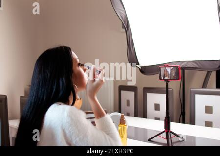 Une jeune femme blogger enregistrement de maquillage tutoriaux - le concept de blogging Banque D'Images