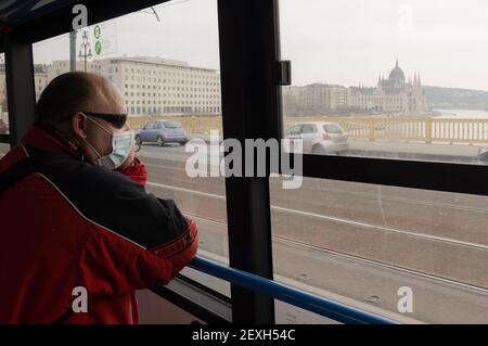 Budapest, Hongrie. 4 mars 2021. Un homme portant un masque facial est vu dans un bus à Budapest, Hongrie, le 4 mars 2021. Le gouvernement hongrois a présenté jeudi un ensemble de règles plus strictes pour lutter contre la troisième vague de pandémie, les nouvelles infections quotidiennes ayant dépassé les 6,000 000, un niveau jamais vu depuis novembre dernier. Credit: Attila Volgyi/Xinhua/Alay Live News Banque D'Images