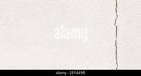 Mur blanc de ciment panoramique avec un grand espace de copie de fissures pour le texte. Grunge béton ciment mur blanc avec un fond et une texture fissurés. Banque D'Images