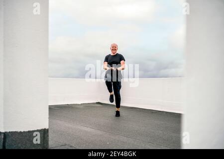 Un homme faisant des exercices cardio sur le toit pendant le verrouillage, Portugal Banque D'Images