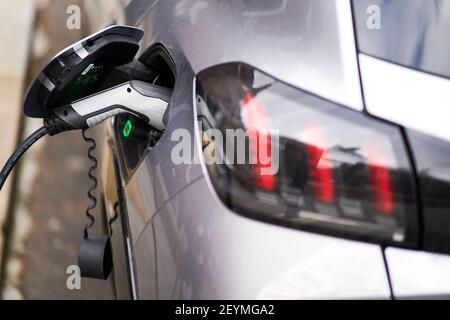 Une Peugeot chargée à l'aide d'un point de charge Source London EV, Londres. Date de la photo : vendredi 5 mars 2021. Banque D'Images