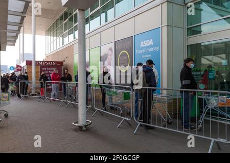 Wembley Park, Londres, Royaume-Uni. 7 mars 2021. Les files d'attente des supermarchés à Asda à Wembley sont revenues ce week-end avant la réouverture des écoles lundi. La variante sud-africaine du coronavirus a été détectée dans North Wembley plus tôt cette semaine et les supermarchés restreignent une fois de plus le nombre de clients entrant dans le magasin. Amanda Rose/Alamy Live News Banque D'Images