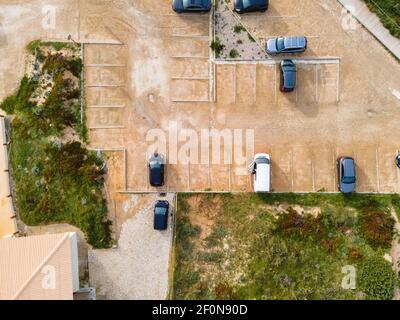 Vue aérienne des véhicules garés dans un parking d'un restaurant sur les falaises face à l'océan Atlantique dans le sud du Portugal, Cascais, Portugal. Banque D'Images