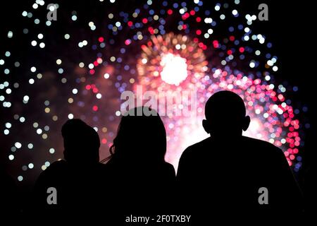 Le président Barack Obama, la Première Dame Michelle Obama, et Malia Obama, centre, regardez la quatrième de juillet fireworks depuis le toit de la Maison Blanche, le 4 juillet 2014. Banque D'Images