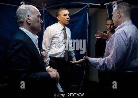 Le président Barack Obama confie avec le conseiller à la sécurité nationale Tom Donilon, chef de cabinet de droite Bill Daley, à gauche, et Ben Rhodes, conseiller adjoint à la sécurité nationale pour les communications stratégiques, à la suite d'une conférence téléphonique sur la Libye avec son équipe de sécurité nationale à San Salvador, en El Salvador, le 23 2011 mars. Banque D'Images