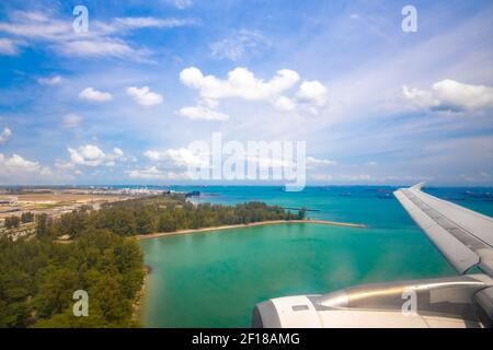vue sur la côte tropicale de l'océan depuis le hublot d'un avion d'atterrissage. voyage de vacances Banque D'Images