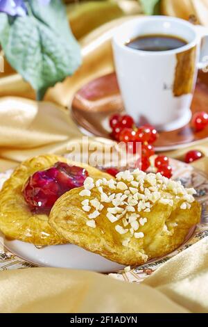 Cheesecake avec confiture sur une assiette contre le fond de la tasse avec un brin de groseilles rouges série plein recettes de cuisine Banque D'Images