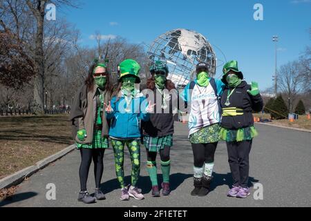 5 femmes à la fin du semi-marathon de la St Patrick et de la course de 5km ronnung, vêtues de masques verts et de costumes de la Saint-Patrick. Queens, New York Banque D'Images