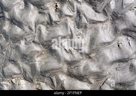 Effet brillant sur la texture naturelle du sable à marée basse Banque D'Images