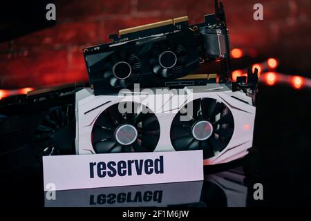 Cartes graphiques de différentes tailles et configurations sur table noire sous lumière néon. Partie de l'ordinateur pour les jeux et l'exploitation minière de crypto-monnaie. Banque D'Images