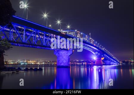 Le Harbour Bridge d'Auckland, Auckland, Nouvelle-Zélande, est illuminé en couleurs la nuit pour célébrer le nouvel an maori, Matariki Banque D'Images