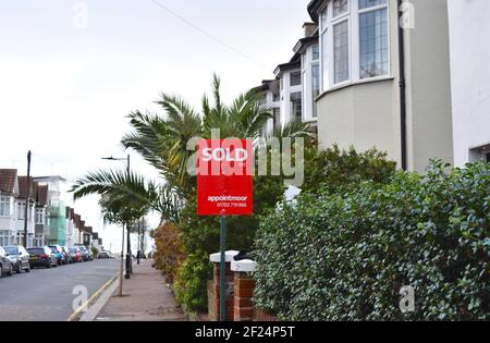 Vendu signe près de la maison en terrasse dans la ville anglaise au bord de la mer. Banque D'Images