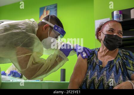 Garde nationale de l'armée de Porto Rico Pvt. Joe Díaz vaccine une personne âgée contre COVID-19 le 9 mars 2021 à Barceloneta, Porto Rico. Banque D'Images