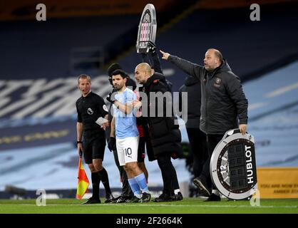 Le directeur de Manchester City, PEP Guardiola (au centre), parle à Sergio Aguero avant d'arriver en tant que remplaçant du coéquipier Kevin de Bruyne (non représenté) lors du match de la Premier League au Etihad Stadium de Manchester. Date de la photo: Mercredi 10 mars 2021. Banque D'Images