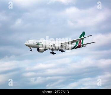 Royaume-Uni, Londres, 16 mai 2020. Un Boeing 777 d'Alitalia qui vole juste en dessous des nuages et effectue des opérations bancaires pour s'aligner sur l'approche finale de Londres Heathrow. Image : a Banque D'Images