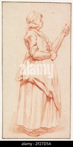 Vrouw a rencontré stok.Standing femme avec un bâton dans les deux mains, et profil vu. Banque D'Images