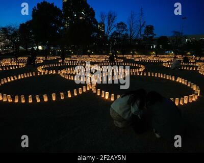 Tokyo, Japon. 11 mars 2021. Les gens regardent les lanternes en papier allumées pour les victimes du tremblement de terre et du tsunami du 11 mars 2011 au Japon pendant le 10e anniversaire de la catastrophe. Credit: AFLO/Alay Live News Banque D'Images