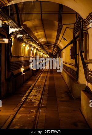 Long and thin underground corridor in Simserhof fortress. Connecting tunnel between for transporting mainly weapons, ammo and soldiers. Stock Photo