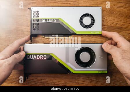 Un ingénieur expérimenté tient en main la comparaison de deux nouveaux GPU Nvidia Quadro RTX 4000 RTX 5000 basés sur la microarchitecture Turing, et les caractéristiques Banque D'Images