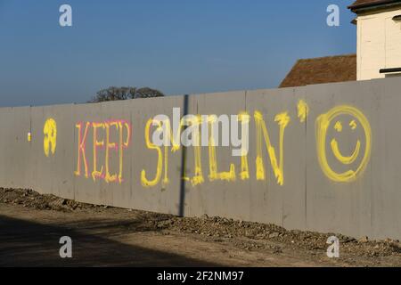 Graffiti « toujours souriant » sur un chantier de construction au Royaume-Uni Banque D'Images