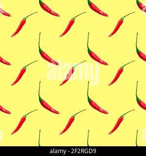 Petits piments rouges chauds isolés sur fond jaune. Motif sans couture Banque D'Images