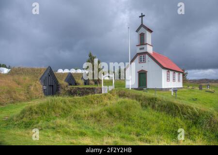 Maisons traditionnelles en gazon et une église blanche à Keldur à Islande Banque D'Images