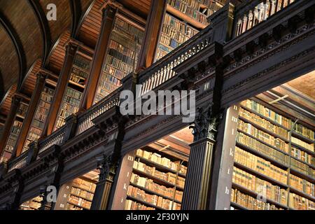 Librairies avec des livres imprimés et manuscrits précieux dans la salle longue de l'ancienne bibliothèque du Trinity College à Dublin, Irlande. Banque D'Images