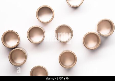 Paliers lisses en bronze sur fond blanc, vue de dessus. Gros plan abstrait avec mise au point sélective Banque D'Images