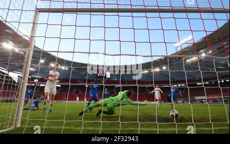 14 mars 2021, Bade-Wurtemberg, Stuttgart: Football: Bundesliga, VfB Stuttgart - TSG 1899 Hoffenheim, Matchday 25 à la Mercedes-Benz Arena. Kasim Adams de Hoffenheim (au centre) marque dans son propre but. Oliver Baumann, gardien de but de Hoffenheim (en face), est impuissante. Sasa Kalajdzic de Stuttgart, à gauche, regarde le ballon entrer dans le but pour 1-0. NOTE IMPORTANTE: Conformément aux règlements de la DFL Deutsche Fußball Liga et de la DFB Deutscher Fußball-Bund, il est interdit d'utiliser ou d'avoir utilisé des photos prises dans le stade et/ou du match sous forme de séquences d'images et/ou de vidéo-li Banque D'Images